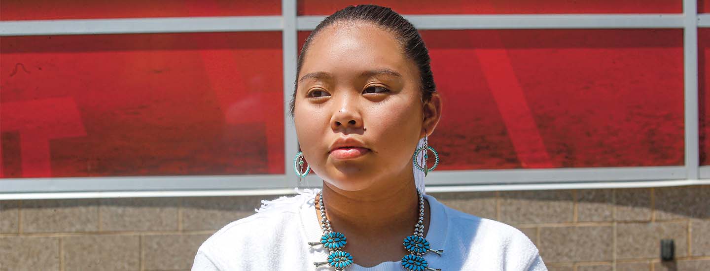 A young woman with a beautiful blue necklace and earrings