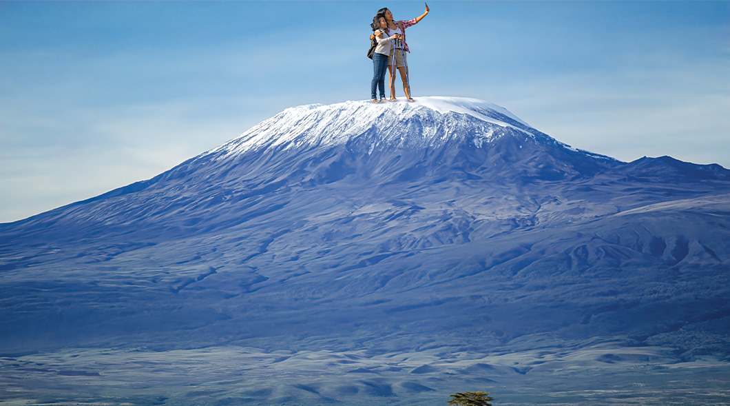 Photoshopped image of a couple taking a selfie on top of Mount Kilimanjaro