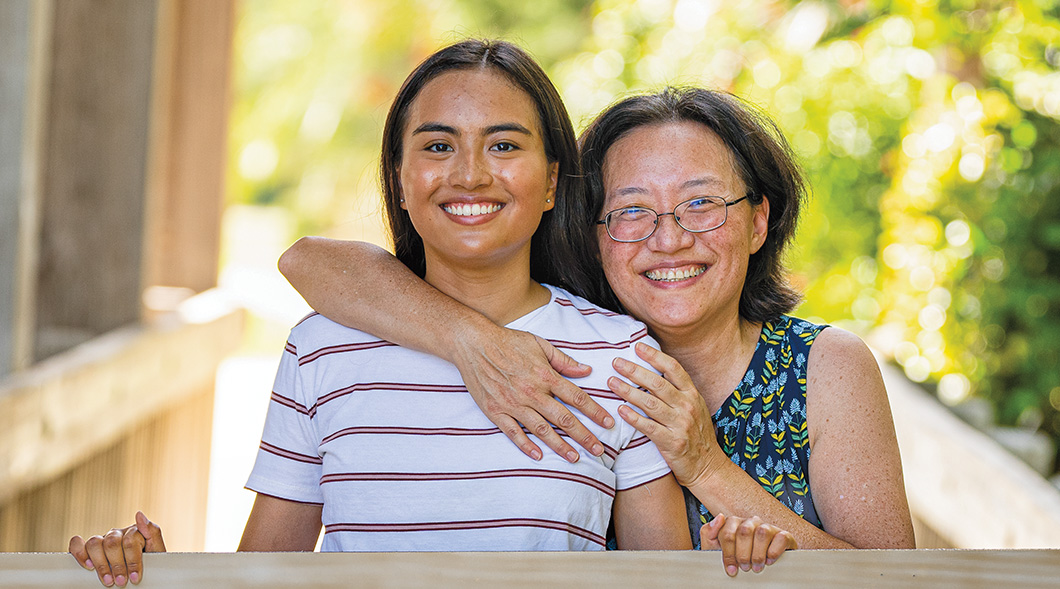 Photo of a mom and daughter posing together for a photo
