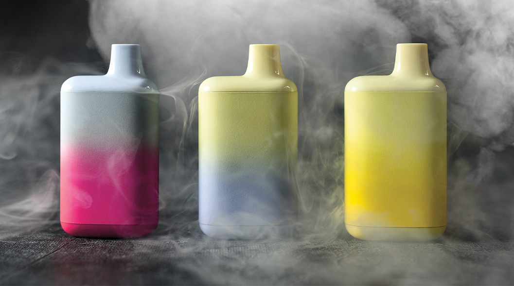 Image of three vapes surrounded by clouds of smoke