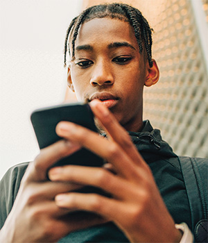 Image of a teen using their cellphone