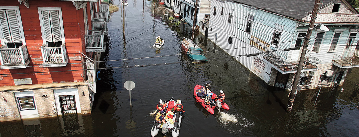 Bird&apos;s eye view of flooded streets in New Orleans with people on boats navigating through